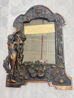Full front view showing entire cast iron frame with mirror and note for scale