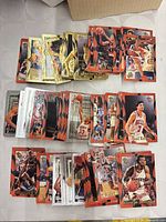 Multiple stacks of Topps Stadium Club cards, showing orange basketball-textured borders and gold-foil inserts