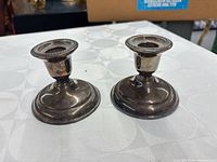 Pair of Birks brass candlestick holders front view