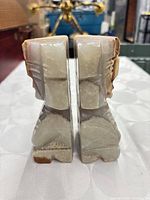 Front view of the pair of carved stone bookends showing polished faces and banded stone layers