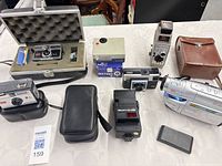 Group shot of all cameras, flash, camcorder, cases and accessories
