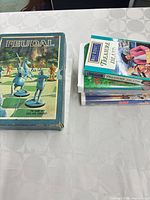 Feudal board game box beside stack of seven VHS tapes