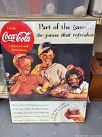 Front view of Coca-Cola hardboard sign with baseball scene and slogans