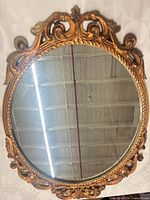 Full view of oval gilt mirror