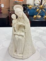 Front view of white porcelain Flower Madonna figurine