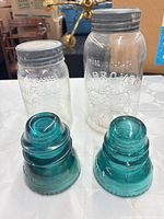 Group shot showing one aqua glass insulator and two Crown canning jars