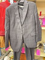 Full view of jacket and trousers hanging