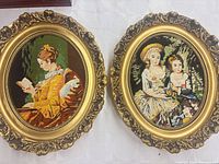 Both oval needlepoints side by side showing designs and frames