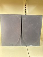 Front view of both Paradigm bookshelf speakers showing grilles and logos