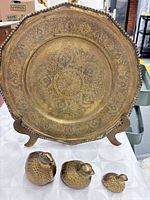 Etched brass plate on stand with three brass quail figurines