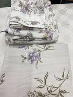 Folded bedding pieces displaying floral pattern