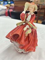 Front view of figurine showing dress and pose