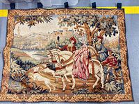 Full view of woven tapestry showing complete design and hanging loops