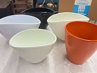 Group of five ceramic vases showing colors and shapes