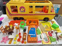 Overall view of camper shell and furniture/accessories spread on table