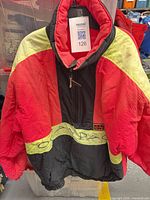 Front view of red, yellow, black Ocean Pacific pullover jacket hanging
