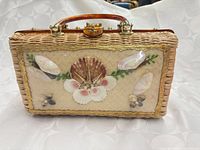 front view showing seashell collage and wicker body