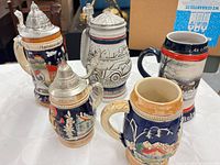 Five steins grouped showing relative sizes and lid presence