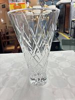 Full view of tapered cut crystal vase standing upright