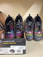 Full view of both shoes with box