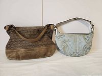 Front view of both Coach handbags
