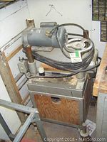 Overall view of planer mounted on wheeled wooden and metal stand