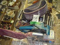 Photo showing Makita belt sander with sanding belt attached and dust collection bag.