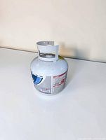 Full view of propane cylinder showing label, valve and overall condition