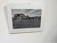 Front view of matted black and white photograph sealed in plastic