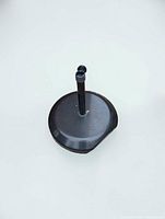 Top view of black circular metal umbrella base with pole sleeve and tightening knob