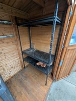 Front view of full shelving unit inside shed