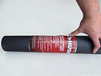 Full view of Husky black vinyl/PVC drawer liner roll with label showing size and brand