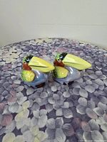 Pair of ceramic toucan salt and pepper shakers front view