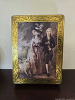 Front view showing Victorian couple image and embossed gold frame