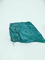 Folded green polyethylene tarp showing drawstring and toggle