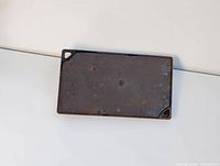 Flat side of cast iron griddle showing wear