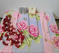 Overview of all jewelry pieces laid out on floral board