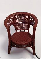 Front angled view of red wicker child chair showing full design