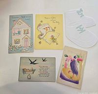 Fronts of five vintage new-baby cards and postcards
