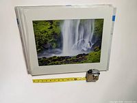 Front view of matted waterfall print with tape measure indicating size