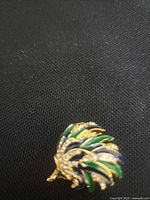 Front view showing enamel quills and rhinestones