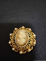 Front view showing cameo, filigree setting and seed pearls