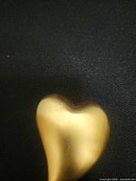 Front view of gold tone heart brooch