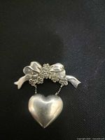 Front view showing bow, flowers and dangling heart