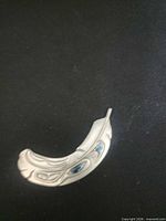 Front view showing silver feather design and abalone inlay