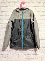 Full view of the Columbia boys rain jacket hanging to show overall design and color