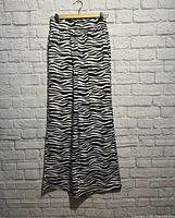 Full view of zebra satin pants hanging