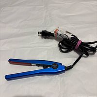 Blue mini FHI hair straightener showing full body, plates, cord and plug