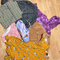 All seven garments spread out to show variety and condition
