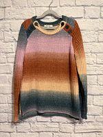 Full front view of gradient knit sweater on hanger